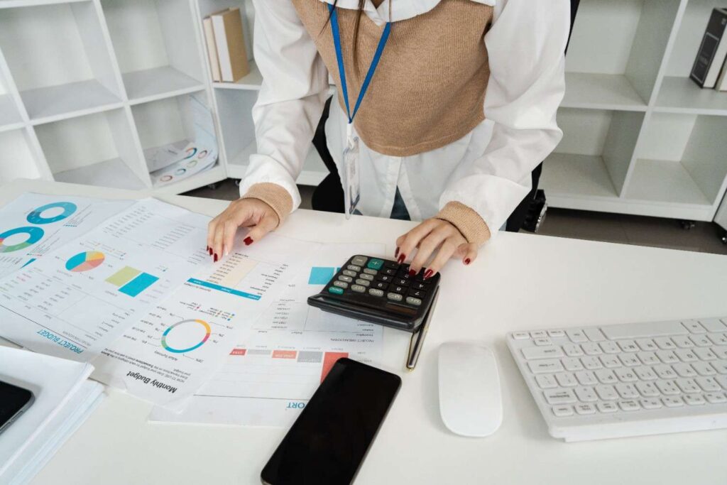 businesswoman analyzing financial reports with cal 2025 02 20 00 09 15 utc (1)