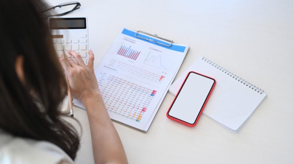 rear view of female accountant using calculator an 2024 12 03 04 04 18 utc (1)